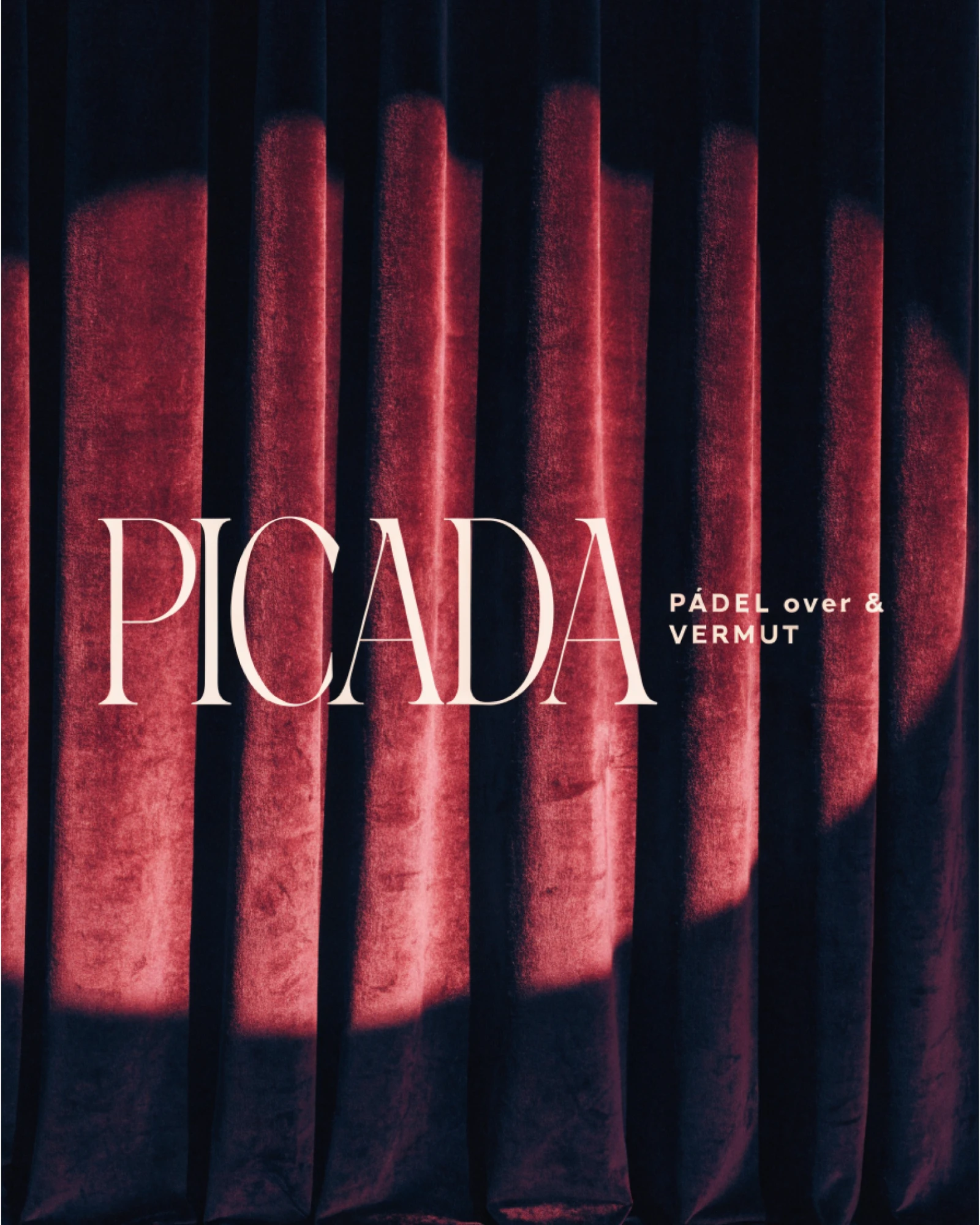 Picada, the logotype projected across a red velvet curtain