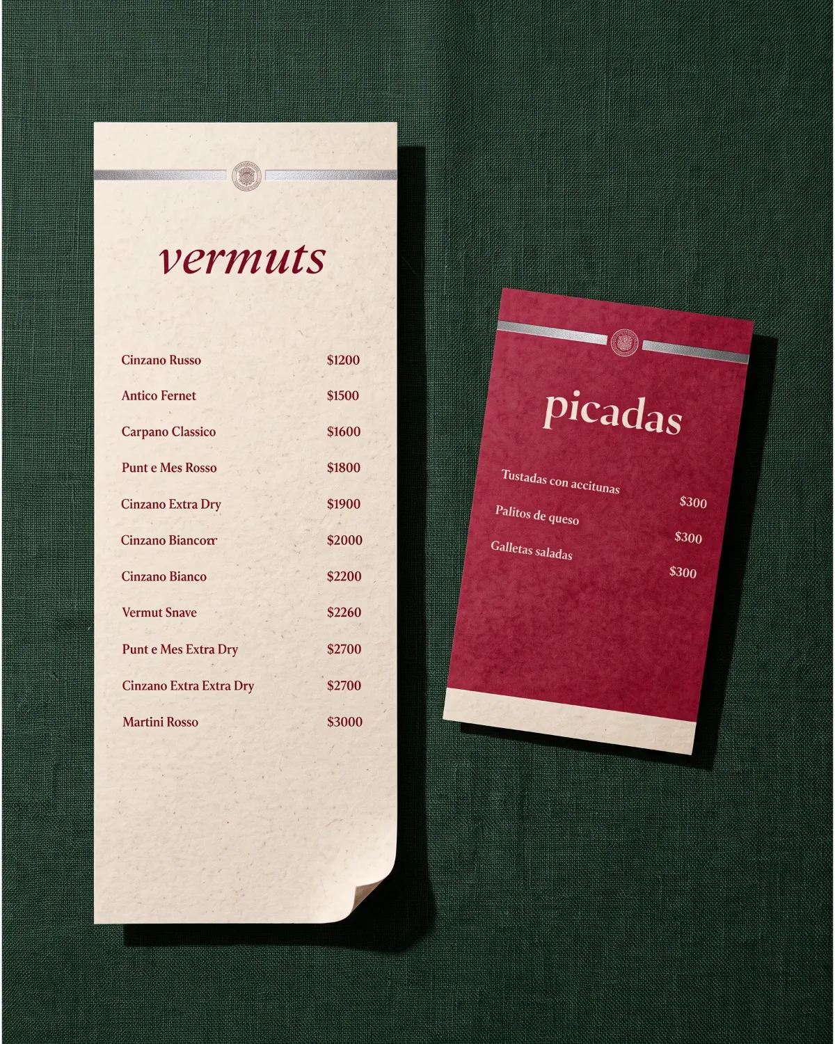 Picada, vermouth and picadas menus on a green felt table